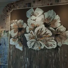Here, you can see the floral design taking shape. The background texture is complete, and I am building up the layers of the white and gold petals on top.