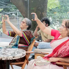 A beautiful moment of connection across generations, as audience members capture memories of the author's reading on their phones.