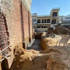 Another view of the foundation work, with reinforced columns rising from the ground. A solid foundation is essential for the integrity of the entire structure.
