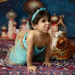A playful, silly face from our little Princess Jasmine. Themed shoots are all about having fun and letting your child's personality shine through.