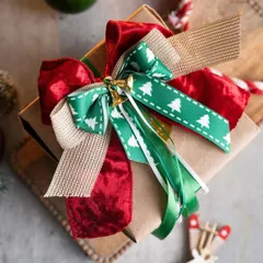 A beautifully wrapped gift is a joy to give and receive. This is an example of the kind of stunning, professional-level gift wrapping you can learn in my workshops, complete with layered bows and festive details.