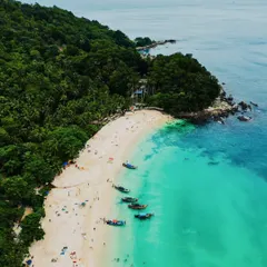 An aerial view of the stunning turquoise waters and white sand beaches of Phuket, Thailand. My coastal aerial photography aims to capture the paradise-like quality of these destinations for tourism brands and travel lovers.