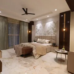 This angle of the master bedroom highlights the beautiful marble flooring and the ample natural light coming through the large windows.