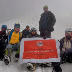 Done! Our team with the banner at the summit of Friendship Peak, 17,346 ft. The fog can't hide the feeling of accomplishment.