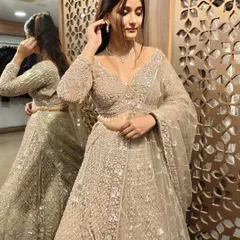 A close-up of the intricately embroidered blouse and the delicate jewelry pairing. This is how you create a high-fashion look with a smart, pre-loved purchase.