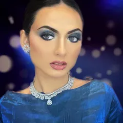 A perfect example of a high-glamour, cocktail party look. The intense blue smokey eyeshadow is balanced with long, luxurious lashes that add texture and drama, creating a truly captivating effect.