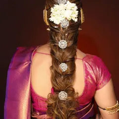 This is another variation of a traditional bridal braid. In our classes, you will learn how to create volume and texture in braids and artfully place accessories and flowers to enhance the style.
