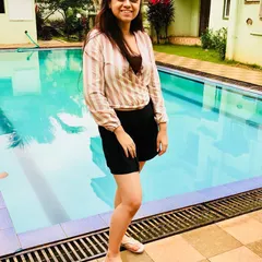 I love wearing stripes on vacation. This striped wrap top helps create a taller, leaner silhouette and is perfect for a poolside look when paired with simple black shorts.