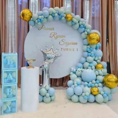 A "Prince" themed first birthday in pastel blue and gold. This setup includes a custom backdrop, a crown foil balloon, a "1" foil balloon, and "BABY" blocks.