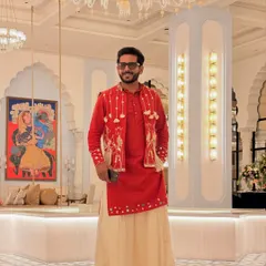 All set for a 'Banjara' themed event in this striking red and cream outfit. The layered look with the embroidered jacket and flowing pants perfectly captures the nomadic, free-spirited vibe.