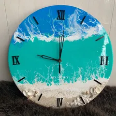 A close-up of an ocean-themed clock, showing the lacing effect of the white resin to create realistic sea foam.