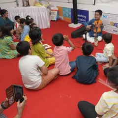 A young violinist captivates his first audience of peers during our Musical Book Tour in Chennai. We create many such opportunities for students to perform.