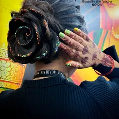 A beautifully crafted rose bun with glitter accents. This is a testament to the detailed and artistic work our students learn to create.