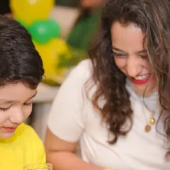 A mother shares a laugh with her child, a precious, candid moment made possible when you're not worried about party logistics.