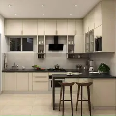 A simple and elegant peninsula extends from the main counter to form a breakfast bar in this L-shaped kitchen. The all-white cabinetry and dark countertop create a timeless and clean aesthetic.