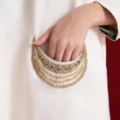 A pocket full of elegance. This close-up reveals the beautifully embroidered pocket detail on an ivory kurta, featuring delicate chains and threadwork.