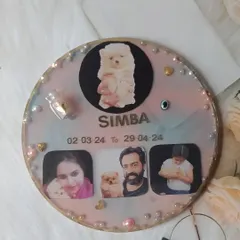 A beautiful memorial plaque for a beloved puppy named Simba. This piece includes his photos, name, dates, and a small bottle with his preserved hair, creating a touching tribute for the family.