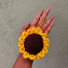 Carry a little sunshine with you with this handmade crochet sunflower keychain. The detailed petals and rich brown center make it a cheerful addition to any set of keys.
