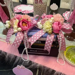 Another element from the coquette theme, where I used books as a decorative base. They are adorned with flowers, pearls, and polka-dot ribbons to tie the entire vintage-inspired look together.