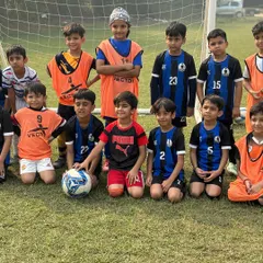 The full U8 squad posing for a team photo before their friendly match against Panthers Football Academy.