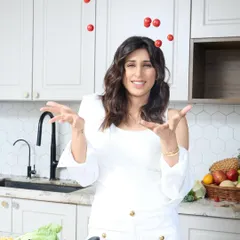 A playful and dynamic shot of Dietitian Nicole juggling tomatoes, adding a touch of fun and personality to her professional portraits.