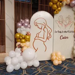 A close-up of the arched backdrop for the baby shower, showing the beautiful line art of the mother-to-be.