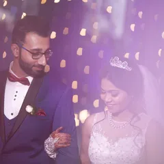 A candid moment from a beautiful Christian wedding. The groom looks at his bride with so much love as they walk together, bathed in the soft, dreamy light of their reception.