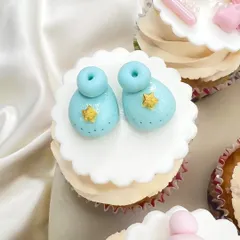 Tiny blue baby booties with little gold stars. Every topper is made with love and attention to detail for your baby shower.