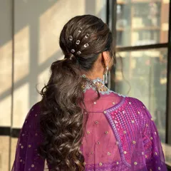 A modern and edgy ponytail for a Sangeet. I've used crystal accessories to create a studded effect, adding a touch of sparkle and making the hairstyle a true statement piece.