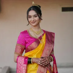 A portrait of a stunning bride on her wedding day. Her smile says it all, and the dark mehendi stain on her hands adds to her bridal glow.
