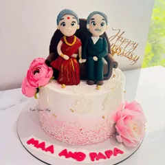 Handcrafted with love for Maa and Papa. This anniversary cake features adorable custom fondant figures of the couple.