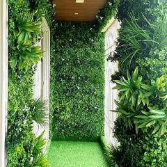 A balcony completely transformed into a green oasis using artificial vertical gardens on the walls and artificial grass on the floor.