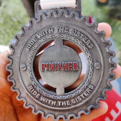 A finisher medal from a "Ride with the Sisters" event. I'm always challenging myself to try new things, and I encourage you to do the same. It's all about finding new ways to move and experience what your body is capable of.