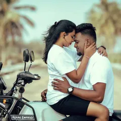 An intimate and cool moment on a Royal Enfield. This close-up shot focuses on the couple's connection and shared love for adventure.