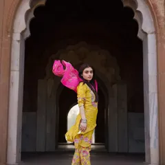 The flow and color of this ethnic outfit come alive against the historic arches. I focus on capturing movement to bring energy to fashion shoots, making the clothing feel dynamic and vibrant. This is a great example of a fashion portrait for an ethnic wear brand.