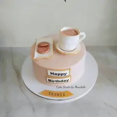 A simple and sweet cake for a tea lover. This design features a hand-crafted, edible teacup and saucer with a biscuit on the side.
