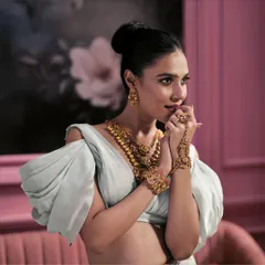 A radiant symphony of ruby hues, where Burmish gemstones whisper tales of love and pride. This layered temple gold set is for the bride walking into her forever.