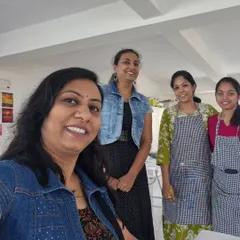 A group of friends posing for a photo after a fun and successful painting workshop.