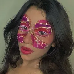 A full-face butterfly mask created almost entirely with rhinestones and glitter. This is an advanced, high-impact look that shows the incredible potential of using gems in your face art.