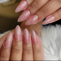 These long almond nails feature a full-coverage, reflective pink glitter polish that catches the light from every angle.