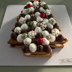 A unique creation for the holidays, my Christmas tree cookie cake is as delicious as it is beautiful. It features layers of cookie and cream, decorated with festive sprinkles and edible ornaments.