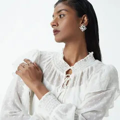 A wet hair look paired with a bold, dark lip for a Westside shoot. This combination creates an edgy, high-fashion vibe that makes the white romantic blouse stand out.