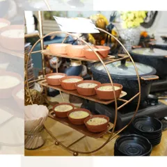 A beautiful display of our desserts, served in traditional earthen bowls on a multi-tiered copper stand. A sweet ending to any meal.