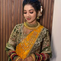 A close-up of the beautiful bride with her eyes closed, showcasing the soft yet defined eye makeup. The look is completed with a traditional 'chandrakor' bindi, an essential part of the Maharashtrian bridal look.