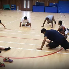 Strength and flexibility are crucial for preventing injuries and improving performance. This image shows our players engaged in dynamic stretching and conditioning exercises during an indoor session.