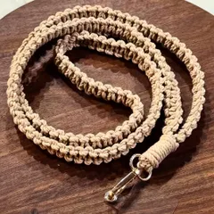 This simple beige lanyard is perfect for a minimalist look. It's handcrafted from eco-friendly cotton cord.