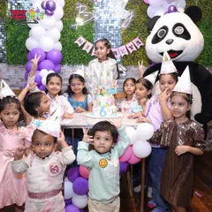 A picture perfect moment from a 6th birthday celebration. With party hats on and our friendly panda mascot joining the fun, we make sure every group photo is full of smiles.