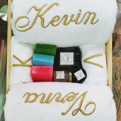 Another beautiful and luxurious couple's gift hamper for a bride and groom. The gold embroidery on the white towels adds a touch of class, paired with colorful handmade soaps and other bath essentials.