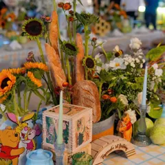 The tablescape included details like a miniature wooden bridge and character cutouts, bringing the world of Winnie the Pooh to every corner of the celebration.