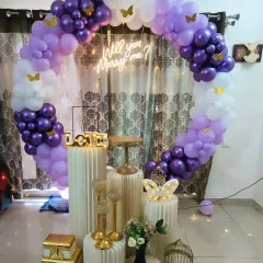 This is one of my signature proposal setups, designed to create a magical moment. It features a 'Will you Marry me?' neon sign set against a full circular balloon arch in shades of purple and white, with elegant white pedestals ready for displaying rings, flowers, or gifts.
